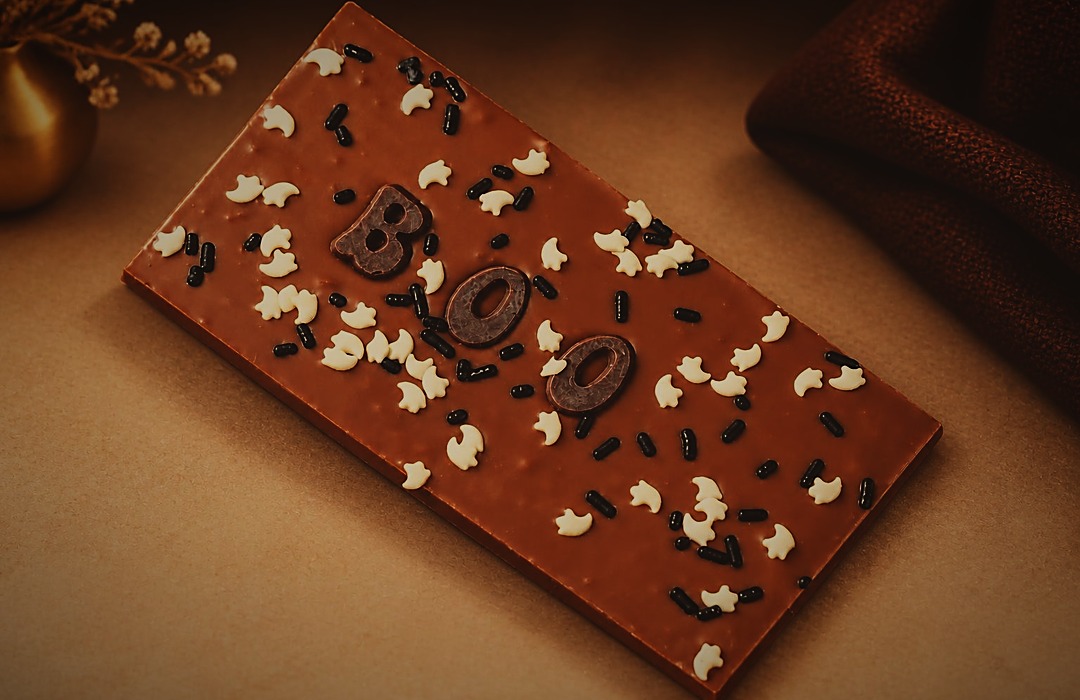 The Spooky Bars chocolate bar topped with a chocolate BOO, white bat sprinkles and black sprinkles